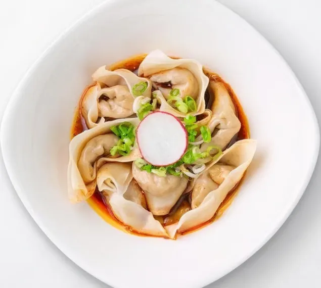 Top view of Chicken Spicy Wontons deressed in a plate for serving