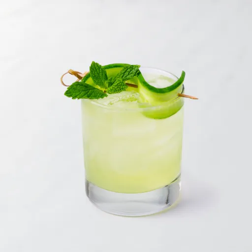Cucumber Gimlet witht he slices of cucumber on the drink
