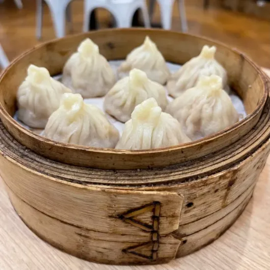 Kurobuta Pork Buns dumplings are placed is a bowl type tray for serving