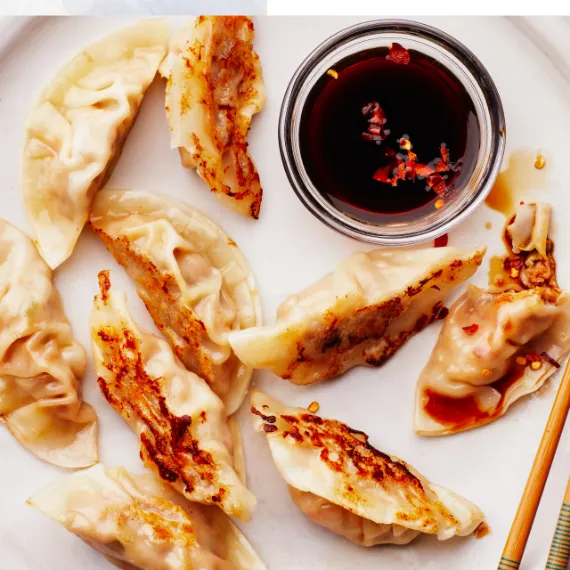 Kurobuta Pork Dumplings placed in the tray with trhe sauce ready to eat