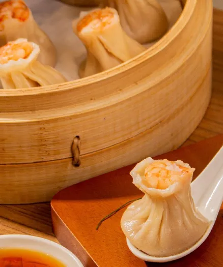 a final version of Kurobuta Pork & Shrimp Shao Mai dumpling and ready to eat ini spoon