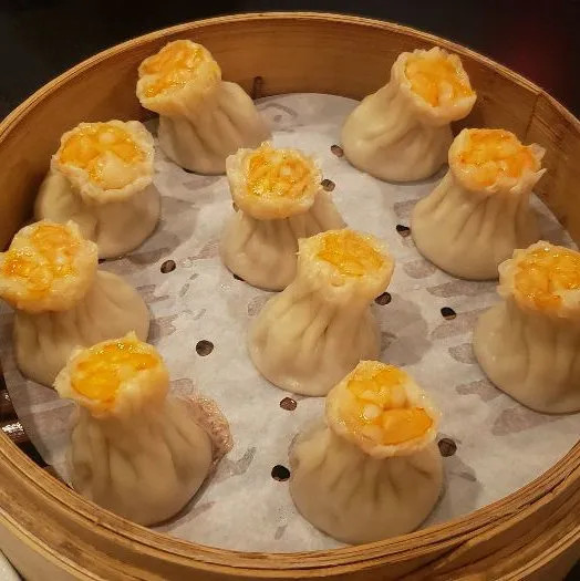 top side view of a final version of Kurobuta Pork & Shrimp Shao Mai dumpling placed in tray for serving