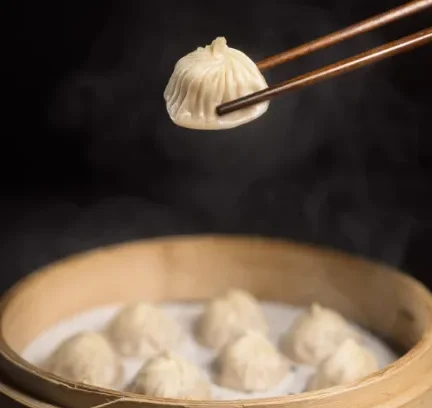 Xiao-Long-Bao dumpling is picked by chopsticks