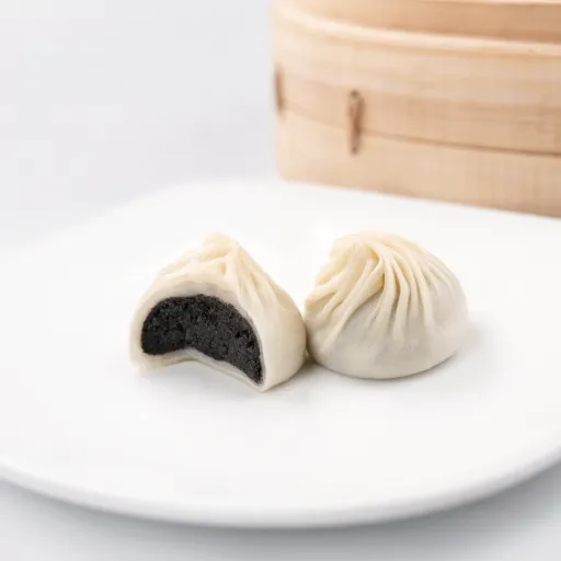 Side view of Sesame & Mochi Xiao Long Bao with visible filling