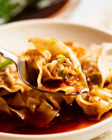 a Wonton Soup ready and picked by someone to eat with a spoon
