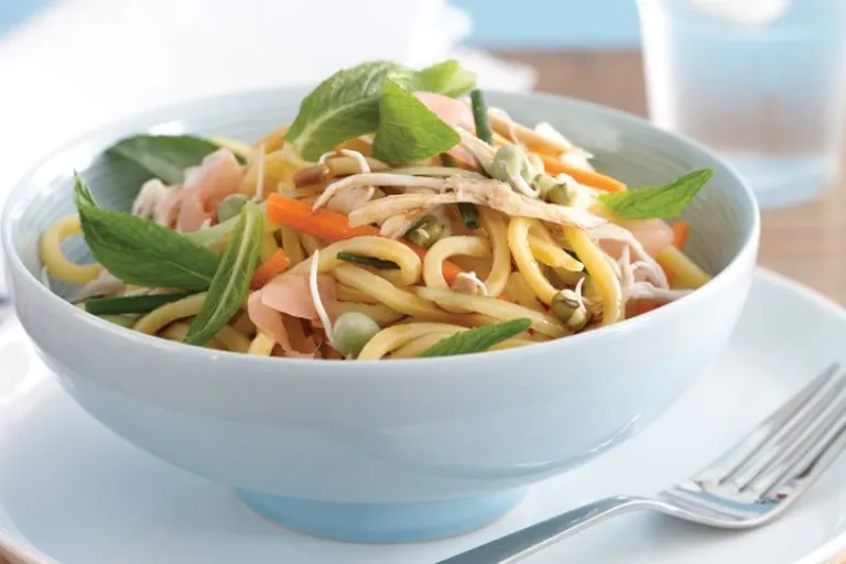 noodle salad garnished with mint and ready to eat