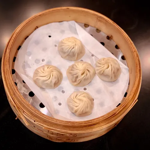 Freshly Baked Truffle & Kurobuta Pork dumplings are set in the tray for serving