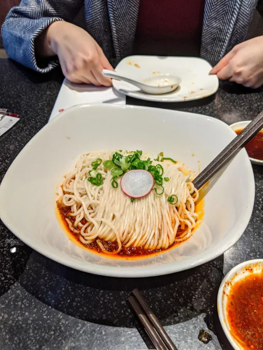 Served Vegan Noodles with Spicy Sauce on the table
