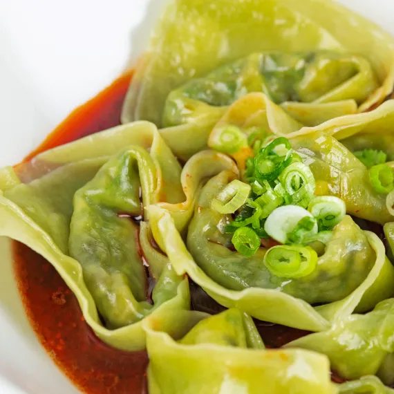 Close Up of Vegan Spicy Wontons garnished with the green chillies